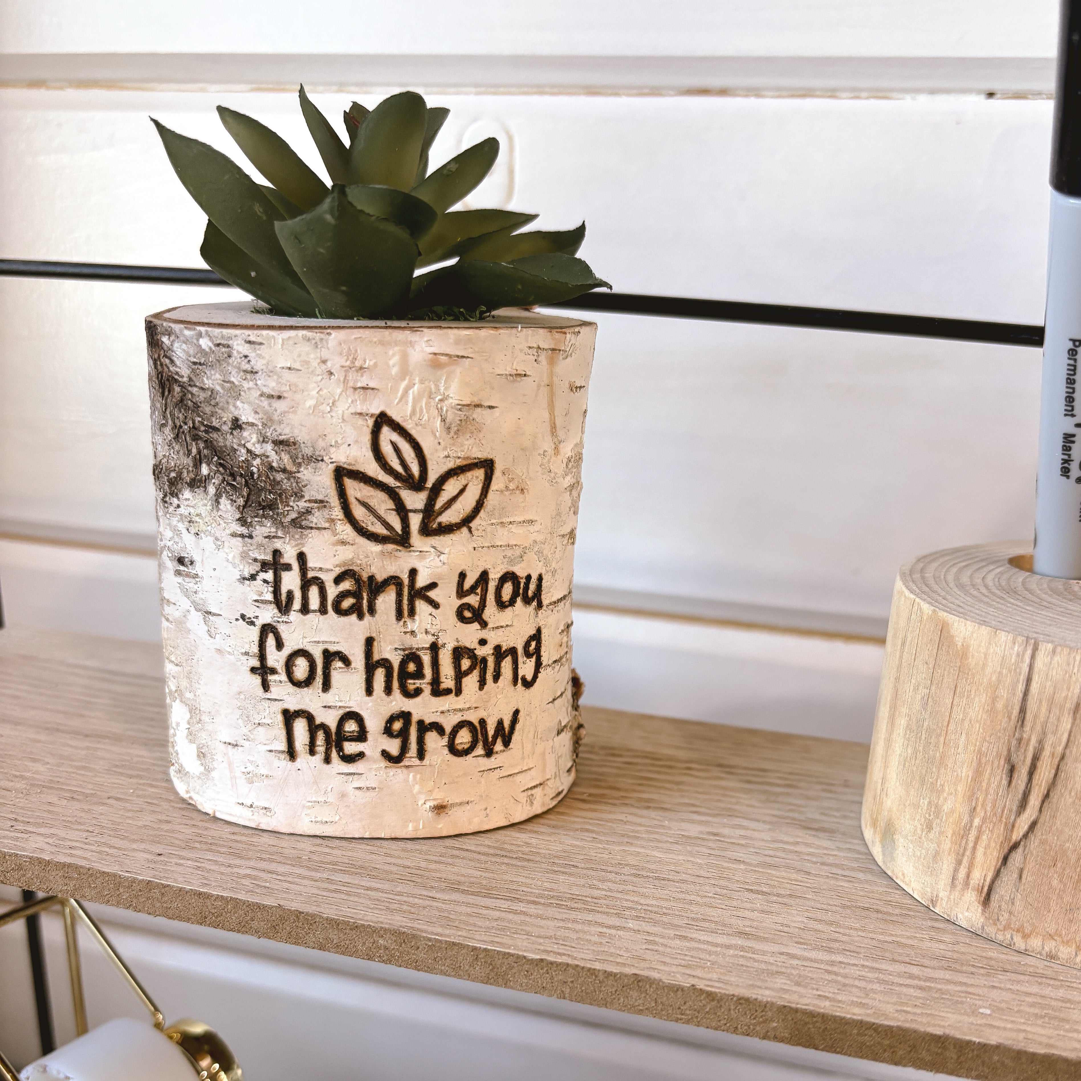 small faux planter on a teachers desk that says thank you for helping me grow