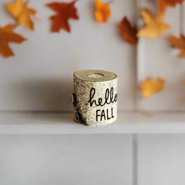 hello fall birch wood candle holder on a shelf with fall decorations