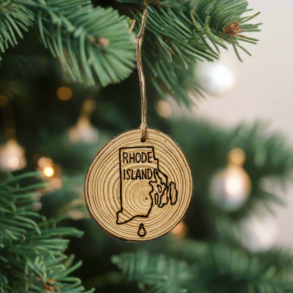 Wooden ornament with 'Rhode Island' engraving on a plain background