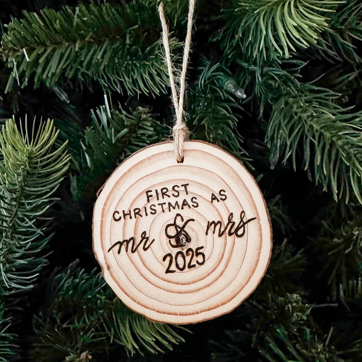 Decorative ornament for the first Christmas as Mr & Mrs 2025, hanging on a tree.